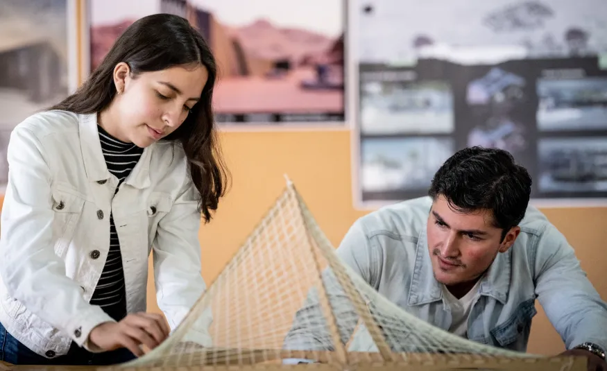 Estudiante de Ingeniería Civil mostrando un maquetado de construcción sustentable
