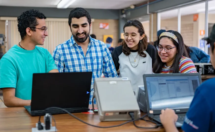Estudiantes de ingeniería en sistemas viendo el equipo de computo disponible en el laboratorio anahuac