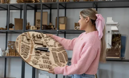 Estudiante de arquitectura admirando un maquetado de urbanismo sostenible