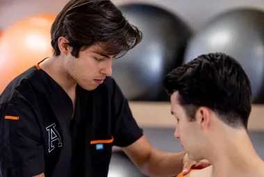 Estudiante de terapia física realizando un ejercicio práctico en el consultorio clínico de la Anáhuac